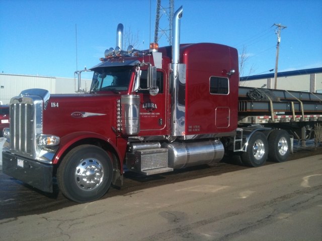 Libra Transport highway tractor hitched to a flat-deck trailer loaded with steel